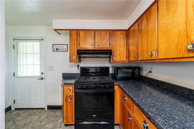 kitchen featuring baseboards, brown cabinetry, black appliances, and under cabinet range hood