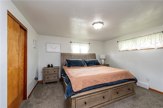 bedroom featuring baseboards, visible vents, and dark colored carpet