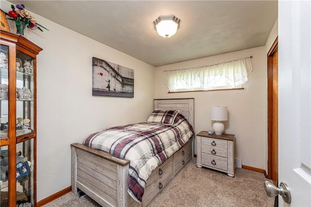bedroom with baseboards and carpet