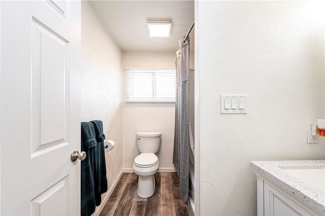 full bath with vanity, baseboards, toilet, and wood finished floors