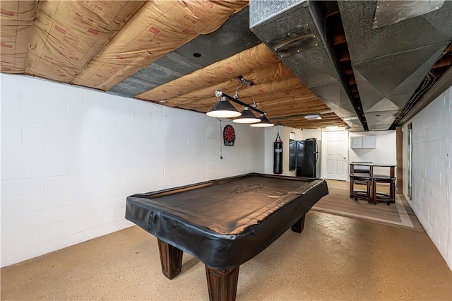 playroom featuring concrete block wall and pool table