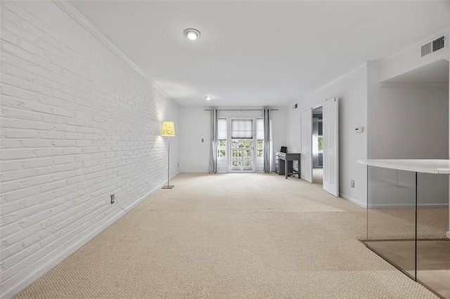 unfurnished living room featuring visible vents, carpet flooring, crown molding, and brick wall