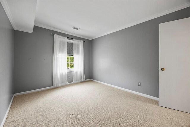 unfurnished room with visible vents, baseboards, crown molding, and light colored carpet