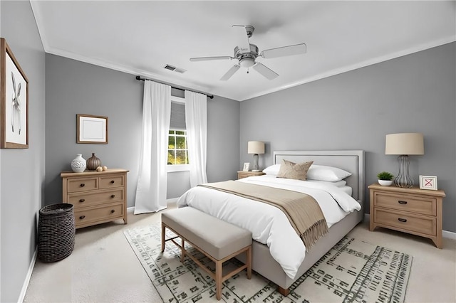 bedroom with crown molding, light colored carpet, baseboards, and visible vents