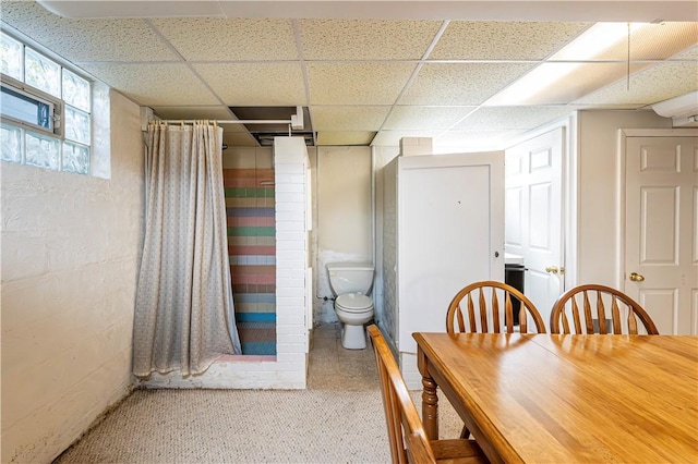 dining area featuring a paneled ceiling