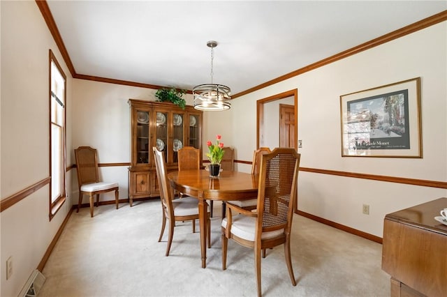 dining space with baseboards, ornamental molding, light carpet, and a notable chandelier