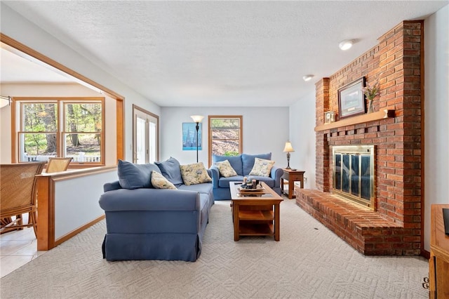living area featuring light carpet, a brick fireplace, and a textured ceiling