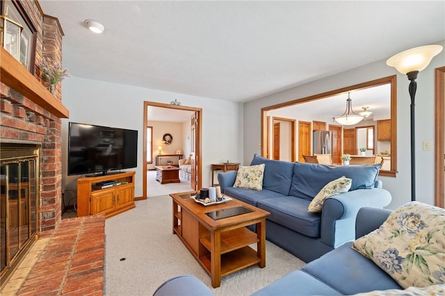 living area featuring light colored carpet and a fireplace