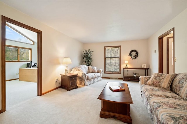 living area with carpet floors, baseboards, visible vents, and a healthy amount of sunlight