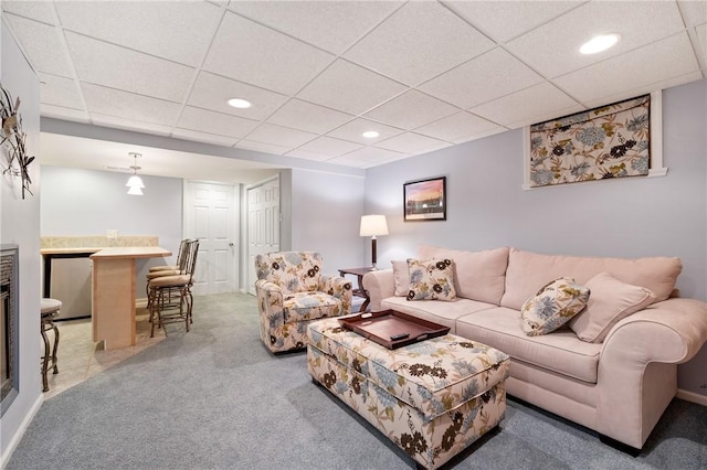 living room with a paneled ceiling, a dry bar, carpet floors, baseboards, and recessed lighting