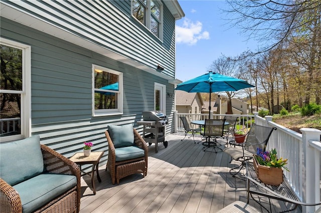 deck with outdoor dining space and grilling area