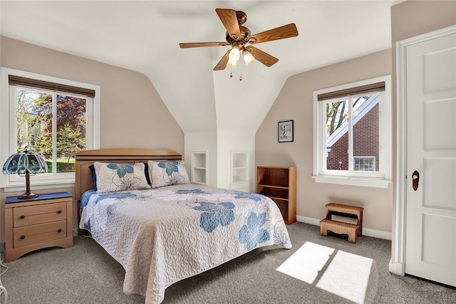 carpeted bedroom featuring baseboards, multiple windows, a ceiling fan, and lofted ceiling