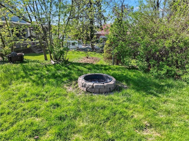 view of yard featuring a fire pit and fence