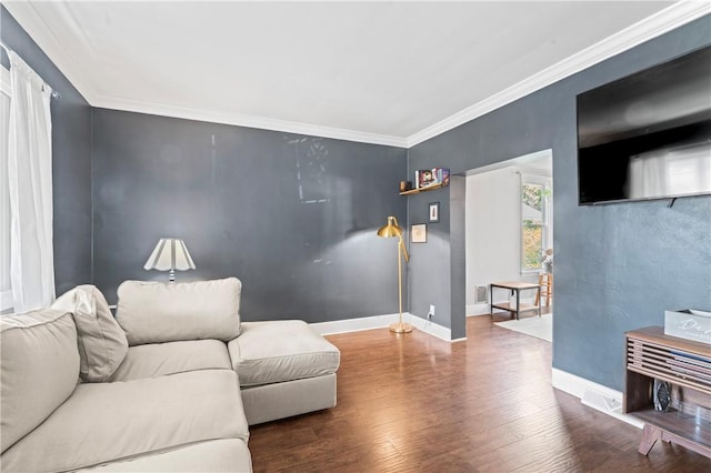 living room with baseboards, ornamental molding, wood finished floors, and visible vents