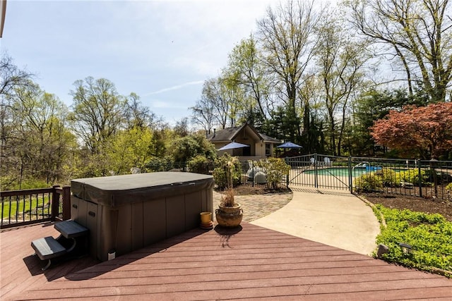 deck featuring fence, a fenced in pool, and a hot tub