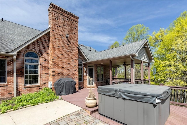 exterior space featuring ceiling fan, a hot tub, grilling area, and a deck
