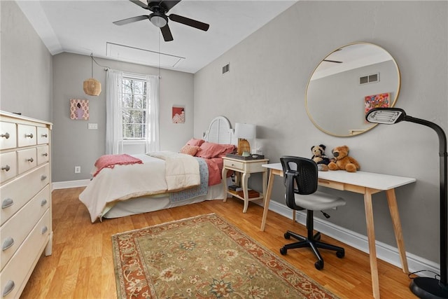 bedroom with baseboards, attic access, light wood-type flooring, and visible vents
