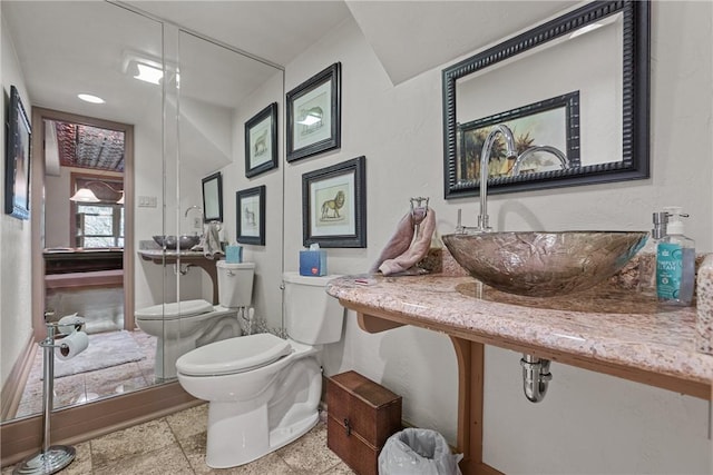 half bathroom featuring a sink and toilet