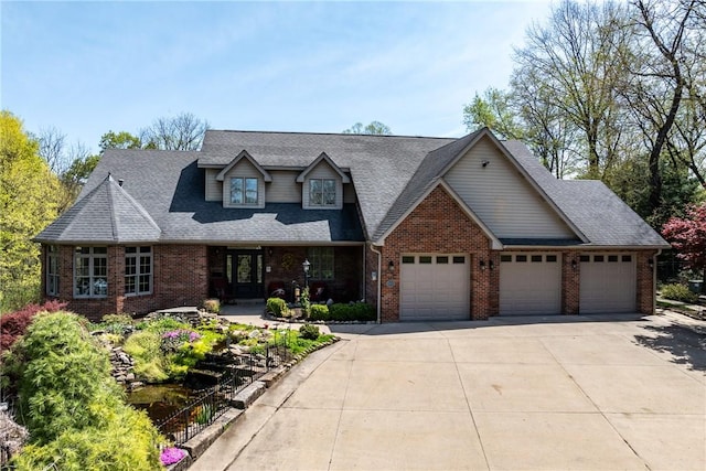 view of front of property with brick siding, a garage, a shingled roof, and concrete driveway