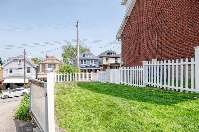 view of yard with a residential view and fence