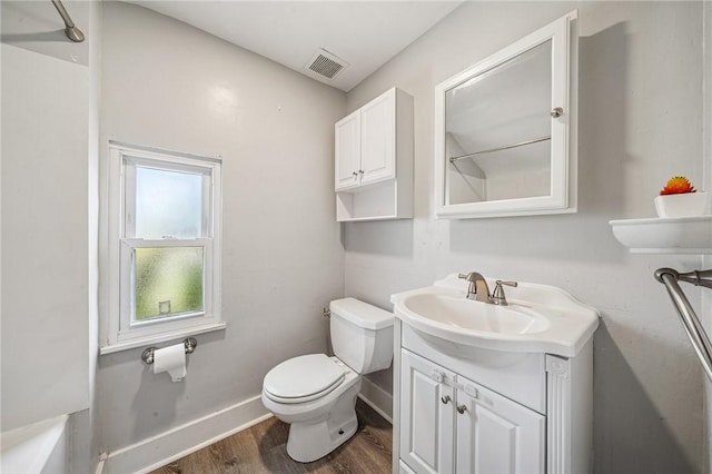 full bath featuring visible vents, wood finished floors, vanity, baseboards, and toilet