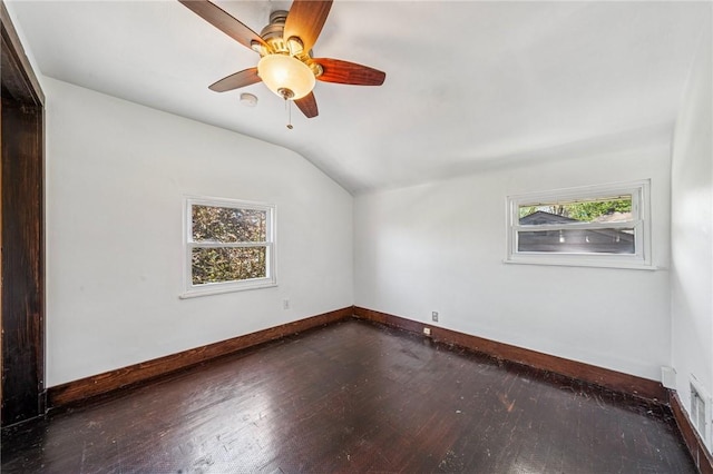 unfurnished room with hardwood / wood-style flooring, ceiling fan, baseboards, and lofted ceiling