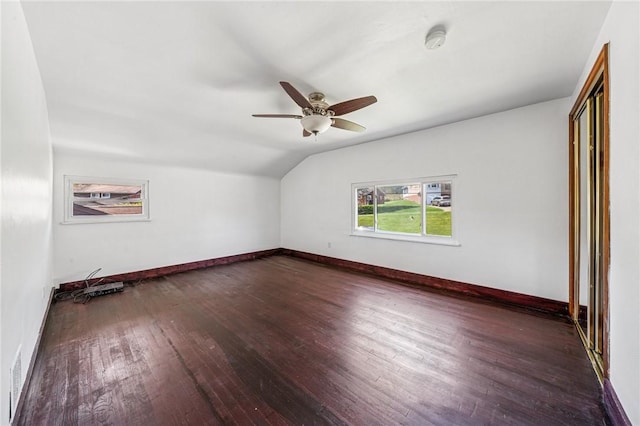 additional living space featuring baseboards, ceiling fan, dark wood finished floors, and lofted ceiling