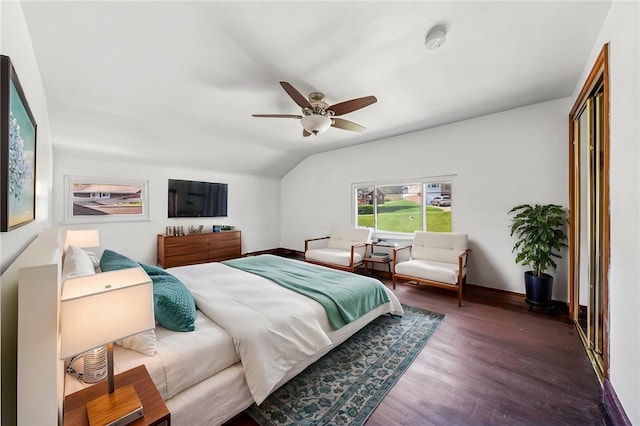 bedroom featuring a ceiling fan, baseboards, wood finished floors, and lofted ceiling