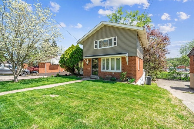 view of front of home with cooling unit, a front lawn, and brick siding
