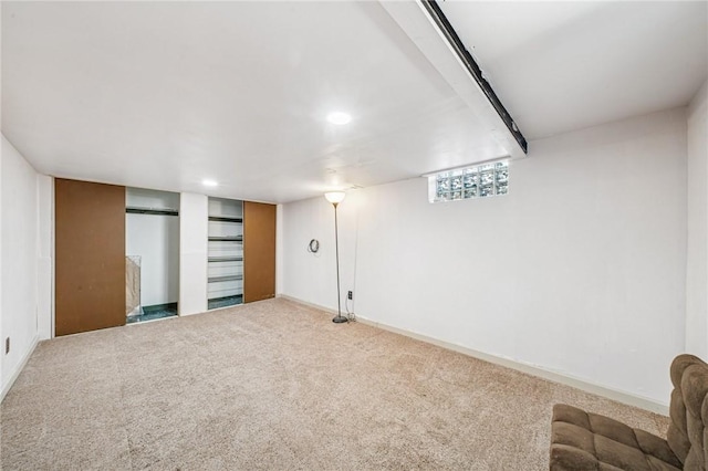 below grade area featuring recessed lighting, baseboards, and carpet
