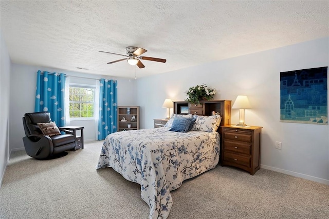 carpeted bedroom with baseboards, a ceiling fan, and a textured ceiling