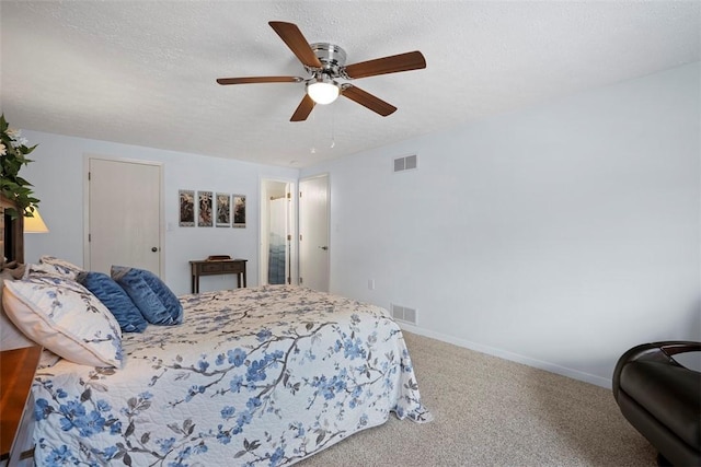 carpeted bedroom featuring visible vents, a ceiling fan, and baseboards