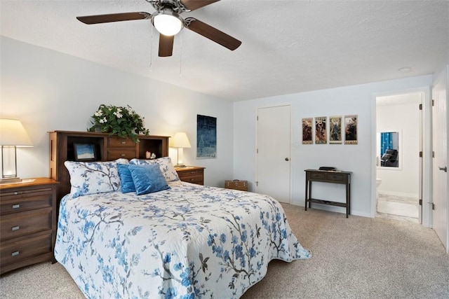carpeted bedroom with a ceiling fan, a textured ceiling, and ensuite bath
