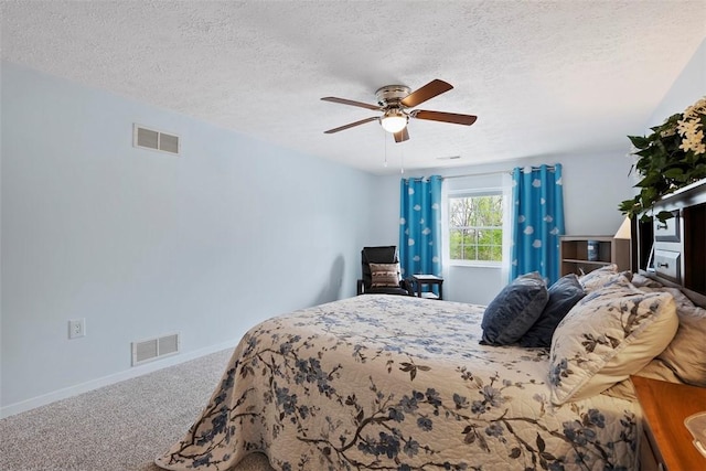 bedroom with carpet flooring, a textured ceiling, and visible vents