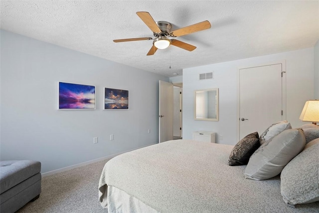 carpeted bedroom with baseboards, ceiling fan, a textured ceiling, and visible vents