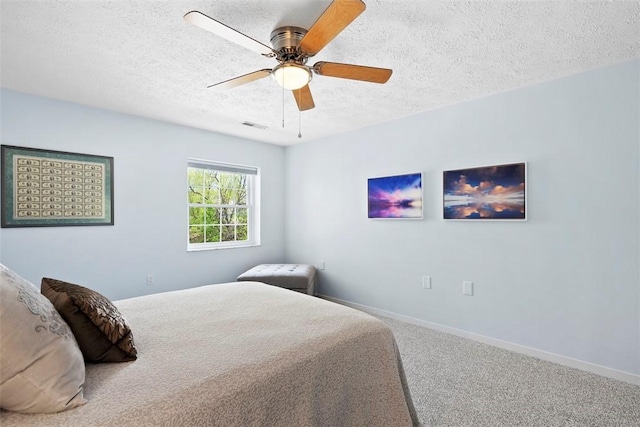 bedroom with ceiling fan, a textured ceiling, visible vents, baseboards, and carpet flooring