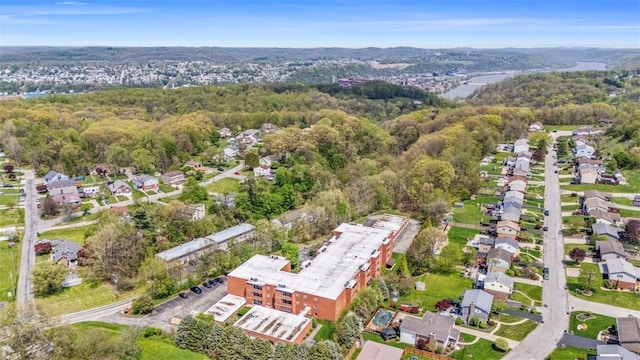 bird's eye view with a wooded view and a residential view