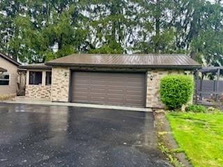 garage featuring aphalt driveway