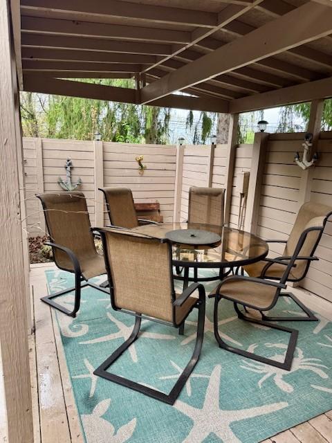 view of patio with fence and outdoor dining area