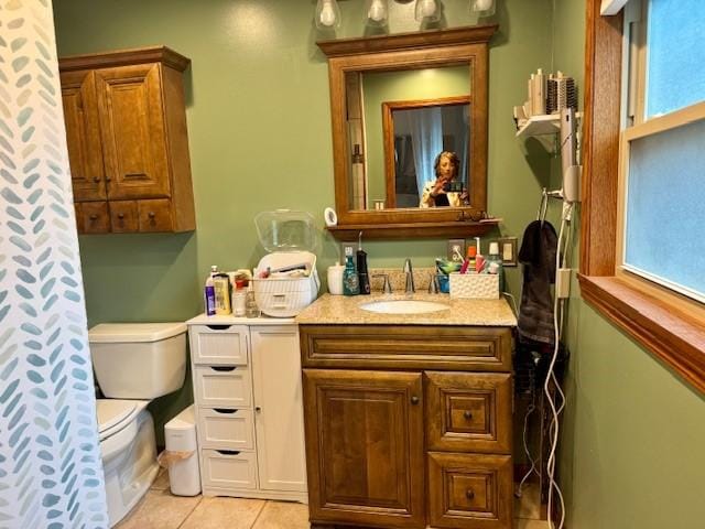 full bathroom with vanity, tile patterned floors, and toilet