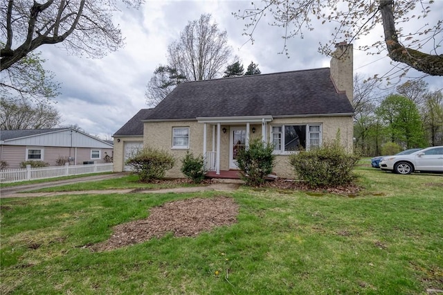 new england style home with a chimney, roof with shingles, a front yard, fence, and an attached garage