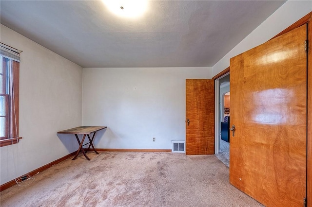 unfurnished bedroom featuring visible vents, baseboards, and carpet floors