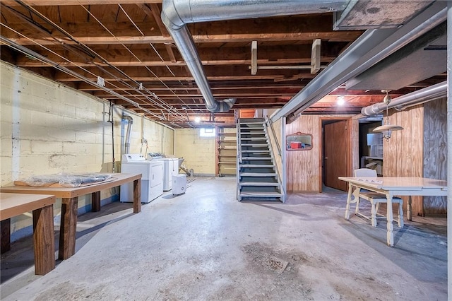 unfinished below grade area featuring independent washer and dryer and stairs