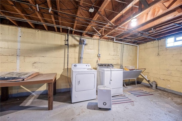 below grade area with a sink and washer and dryer