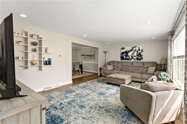 living room featuring baseboards, recessed lighting, wood finished floors, and visible vents