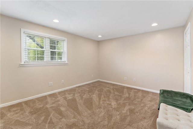 carpeted empty room with baseboards and recessed lighting