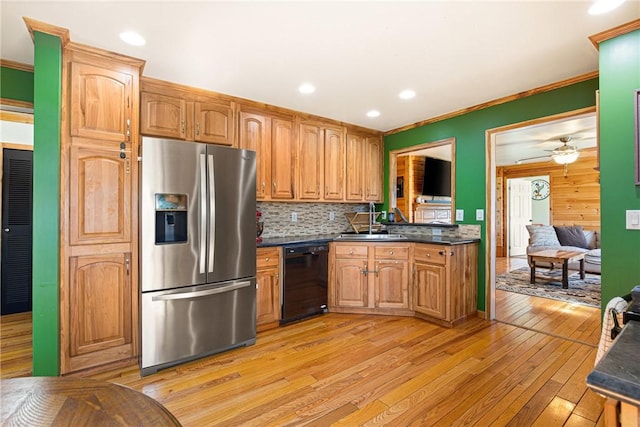 kitchen featuring black dishwasher, dark countertops, light wood finished floors, and stainless steel fridge with ice dispenser