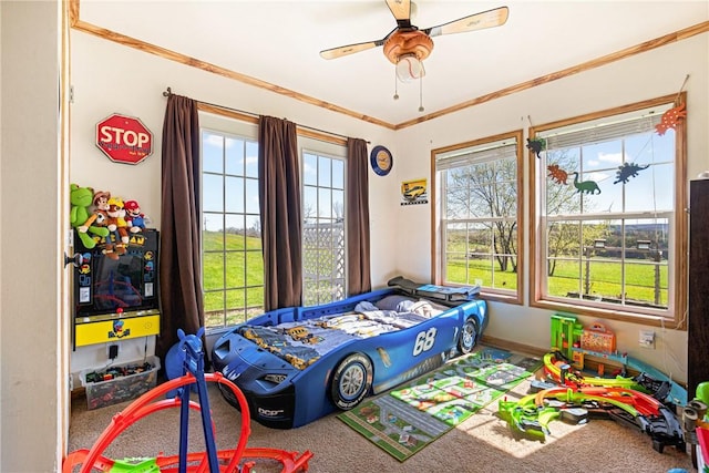 bedroom featuring crown molding, carpet flooring, and a ceiling fan