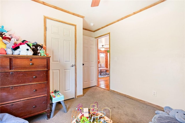 carpeted bedroom with baseboards, ornamental molding, and ceiling fan