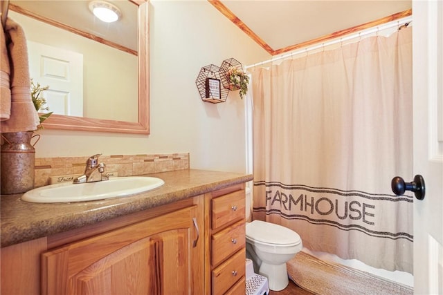 bathroom featuring toilet, decorative backsplash, curtained shower, and vanity